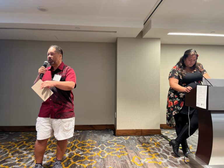 Carl Johnson speaking and Tafilisaunoa Tolefoa on the podium